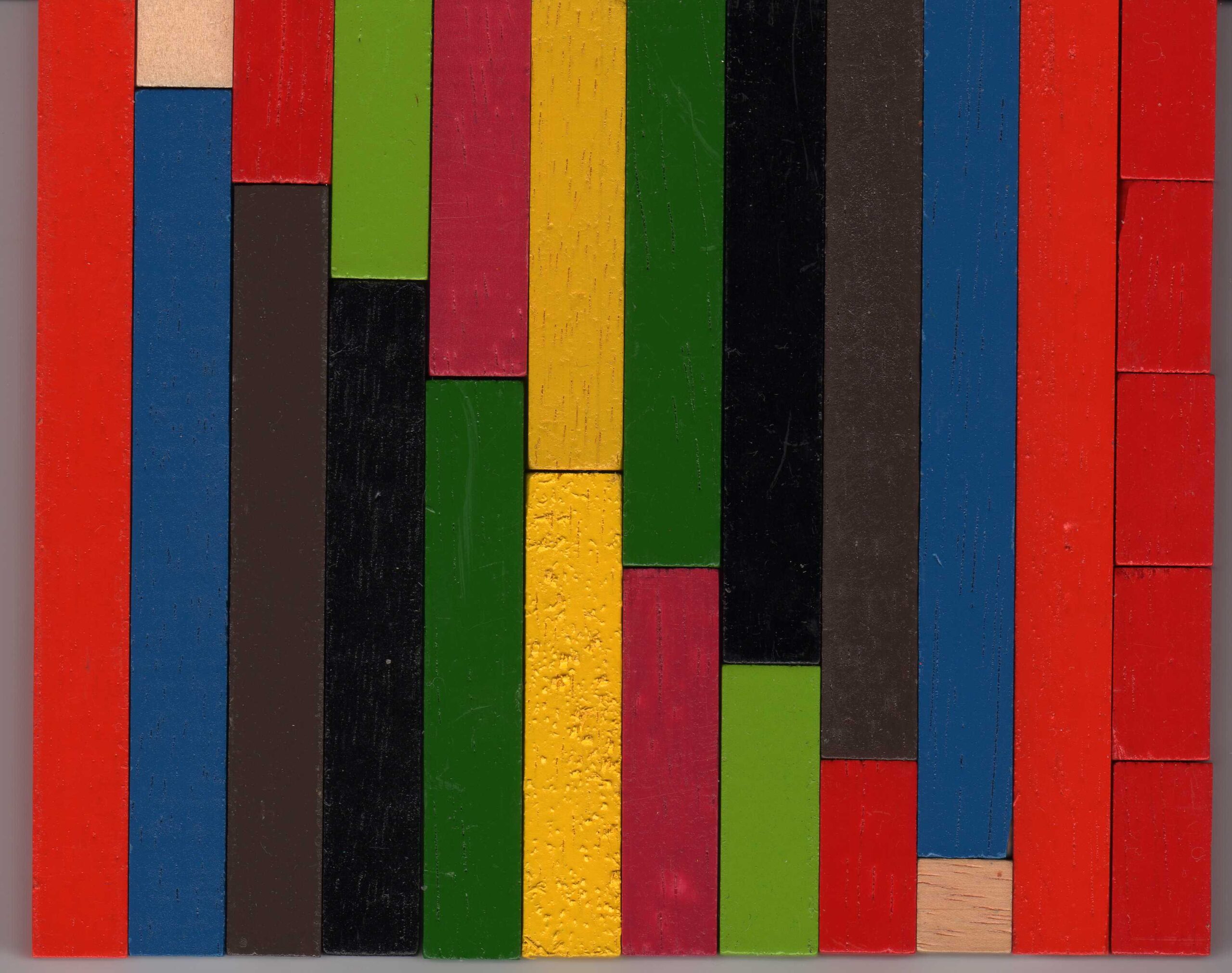 Red, blue, green, yellow, black and natural-coloured wooden rods arranged side by side.