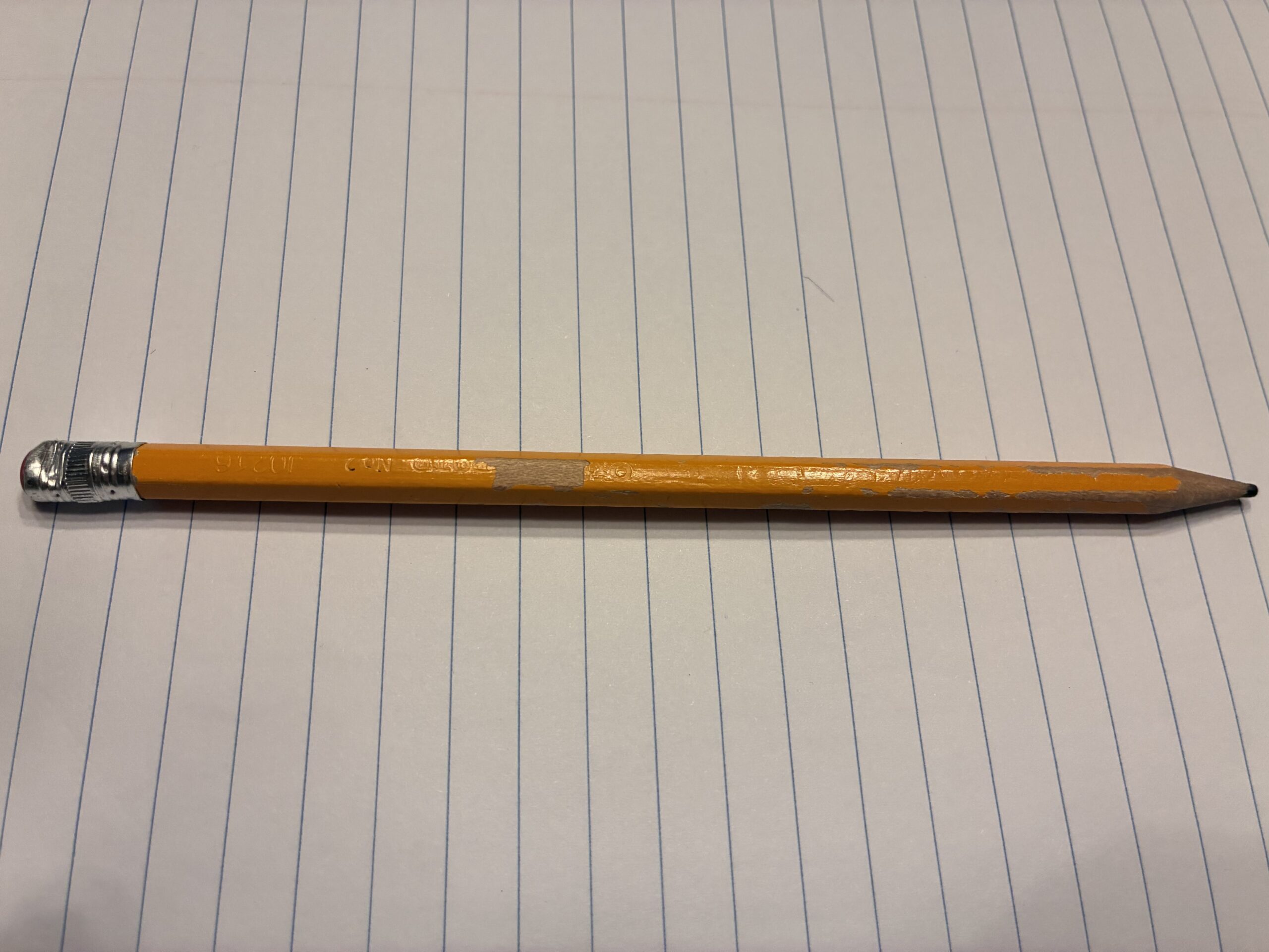 A pencil resting on a notebook.